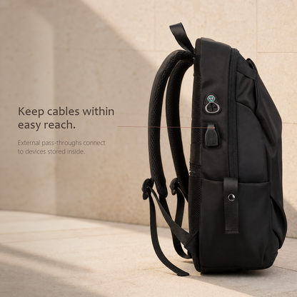 CommuteCore structured laptop backpack in black, side view showing external cable pass-through ports for charging devices stored inside.