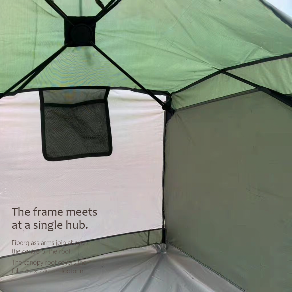 Interior of the HarperShelter camping tent showing the central frame hub and full canopy