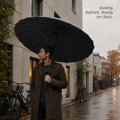 Man holding an open RainSpan automatic umbrella in classic black on a rainy city street with the headline Quietly Refined, Ready for Rain.