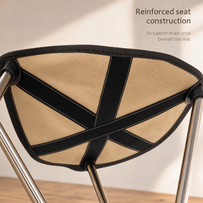 RestStep folding cane seat in beige, underside view showing crossed reinforcement straps.