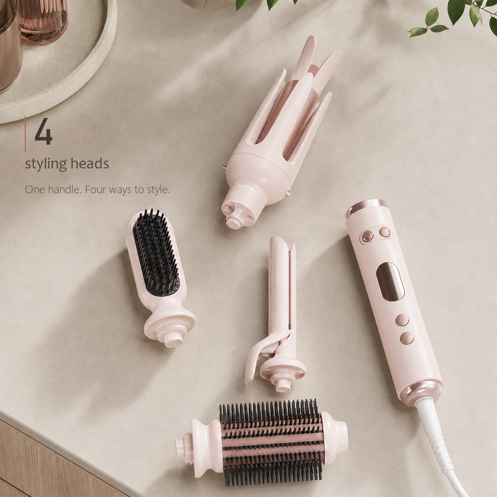 StyleOrbit multi-head hair styler in pink shown from above with its handle and four detachable heads arranged on beige.