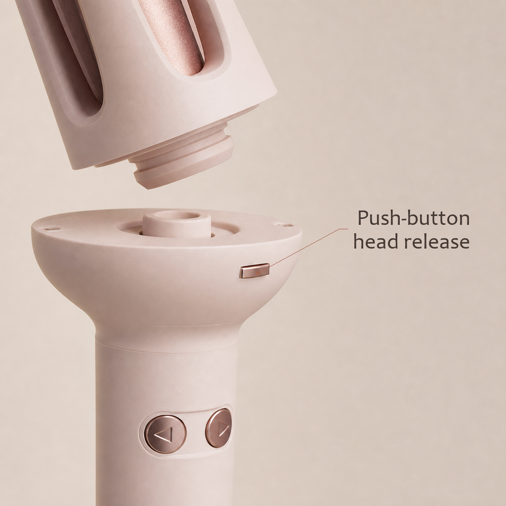 StyleOrbit hair styler in pink, close-up of the push-button head release between the handle and the curl head.