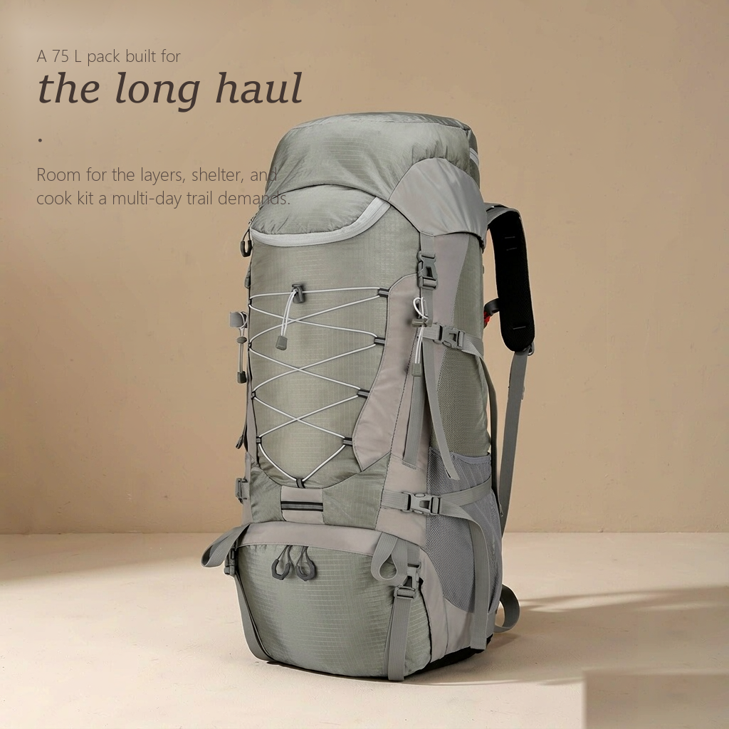 TrailFrame 75L hiking backpack in sage gray-green, three-quarter front view with bungee lacing and mesh side pockets.
