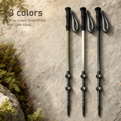 TrailGlide telescoping trekking poles in Lake Green, Shell White, and Slate Black arranged on a rock.